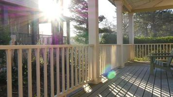 Sunlight shines through railings on beach house porch video