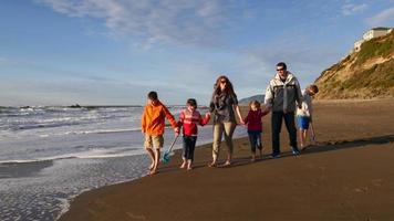 Family walking on beach video