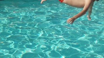Boy splashing into pool in slow motion, shot on Phantom Flex 4K