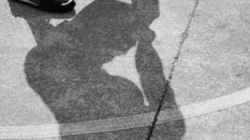 Shadow and feet of basketball player dribbling video