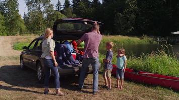 Family unloading car at camp site video