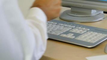 Timelapse shot of businessman typing on keyboard at office desk video