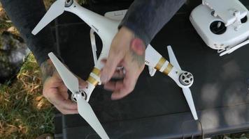 Man preparing drone for flight video
