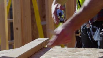Closeup of construction worker measuring board video