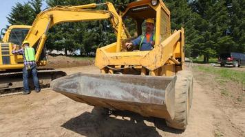 Construction worker driving excavation equipment video