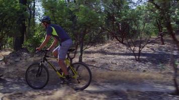 Man riding mountain bike in nature video