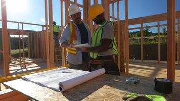 Construction workers using digital tablet on job site video