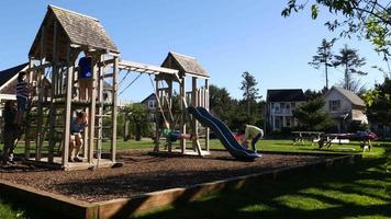 Family playing at park playground video