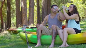 Couple with kayaks take a water break video