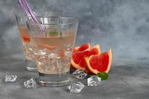 Cocktail with grapefruit on a light background photo