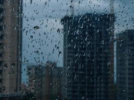 Raindrops on window. wet window city lights rain drops photo