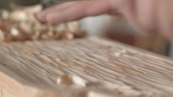 a woodcarver processes a pine wood board with a chisel video