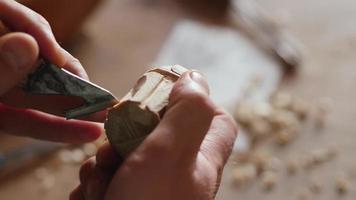 a woodcarver carves a helmet of a knight video