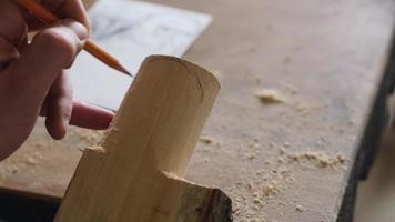 wood carver draws a sketch of a robot head video