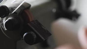 worker sharpens a chisel on an electric grindstone video