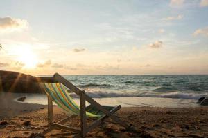 Summer vacation deckchairs on tropical beach photo