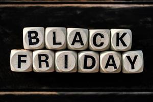 Black friday concept with wooden block on wooden table background photo