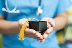 Asian doctor study learn with graduation gap hat in hospital photo