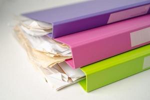 File Folder Binder stack of multi color on table in office. photo