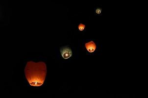 Flying lantern in the dark sky photo