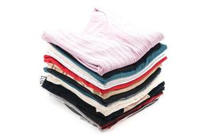 Stacks of clothing on white background photo