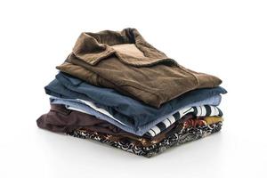 Stacks of clothing on white background photo