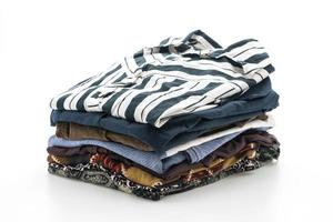 Stacks of clothing on white background photo