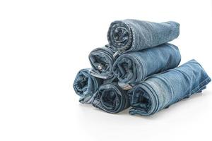 Stacks of jeans clothing on white background photo