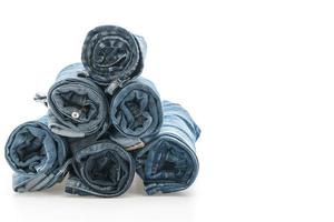 Stacks of jeans clothing on white background photo