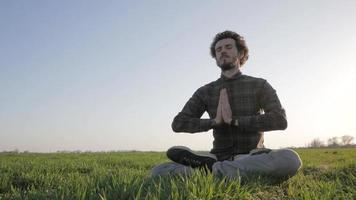 jovem relaxando e meditando no campo video