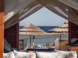 View Of A Beach Umbrella Made Of Straw And Blue Sky photo