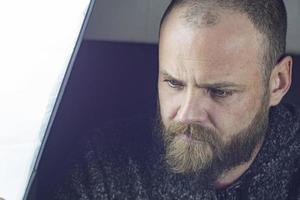 Portrait Of A Bald Bearded Man With Beautiful Blue Eyes photo