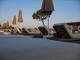 sunbeds and umbrellas near resorts pool photo
