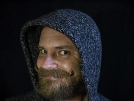 portrait of a man with a beard and mustache in the hood photo