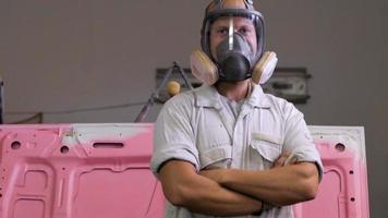 Process of car painting in workshop, worker in mask video