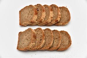 Slices of rye bread on white background photo