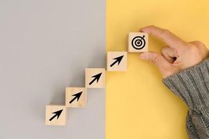 Businessman hand arranging wood block with icon business strategy photo