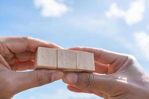 Blank wooden cube that you can put text or icon on in hand hold photo