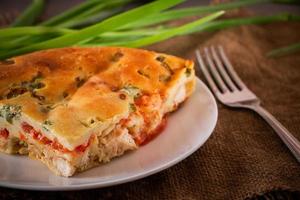 Homemade pie with chicken, herbs and tomatoes on a plate photo