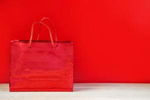Black friday sale concept. Red shopping bag photo