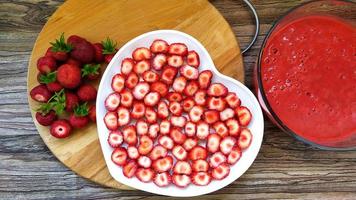 Strawberry slices on a white plate in the shape of a heart photo