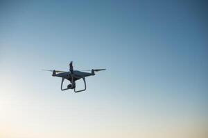 White drone fly in the sky recording a video photo