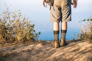 Man traveling with backpack hiking in mountains photo