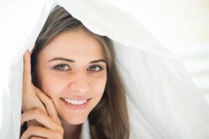 Portrait of woman lying at the bed photo