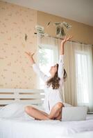 Woman with dollar bank note on the bed photo