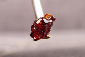 Dark cannabis resin wax on dab tool closeup photo