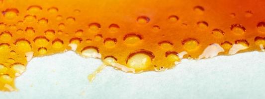 Medical cannabis wax running down the paper, bubbles resin marijuana photo