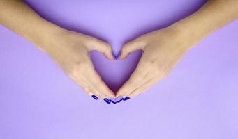 Girl holding hands with heart. Stylish trendy photo