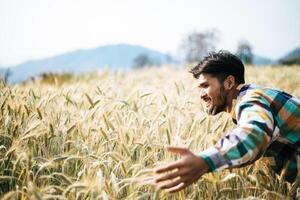 Handsome man farmer with barlay field photo