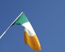 Irish flag over blue sky photo